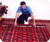 Terchnician picking up area rug
